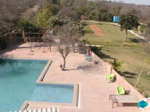 Luxurious farmhouse for film shoots in Delhi NCR, Gurgaon, and Noida with stunning pool area and scenic surroundings.