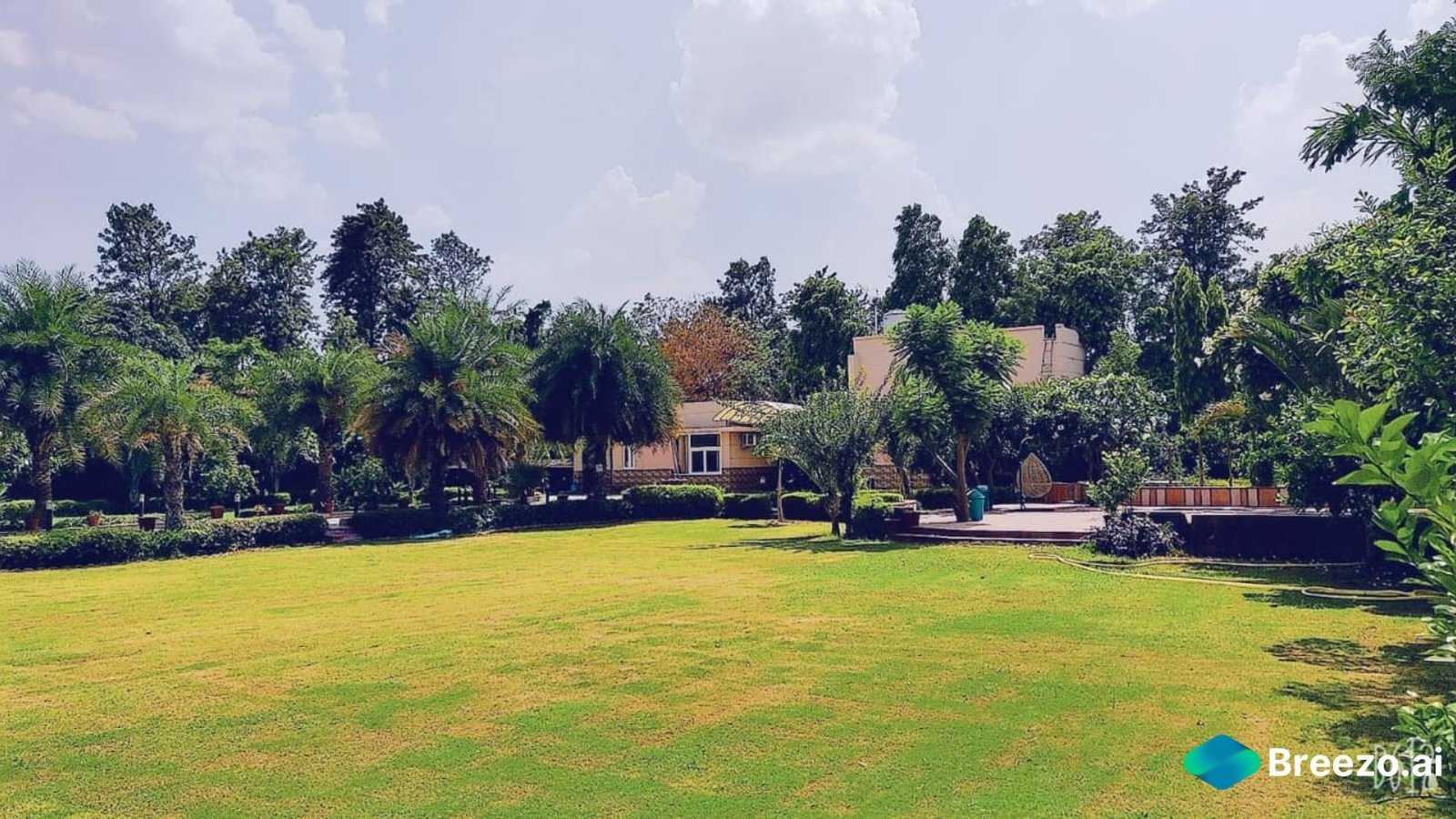 Farmhouse for film shoots in Delhi NCR, Gurgaon, and Noida - A serene poolside setting amidst lush greenery.